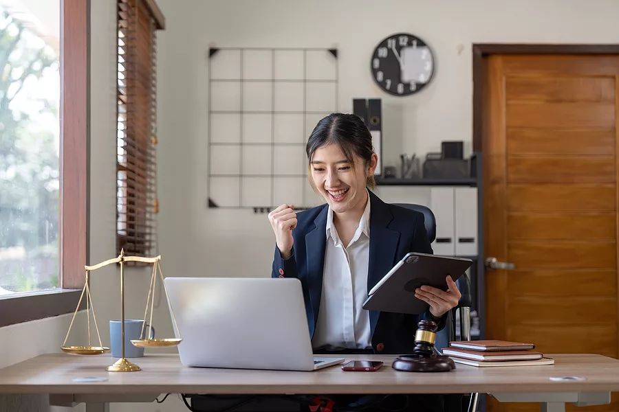 Excited businesswoman at her desk