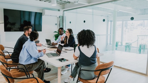 A group of people sitting around a conference table