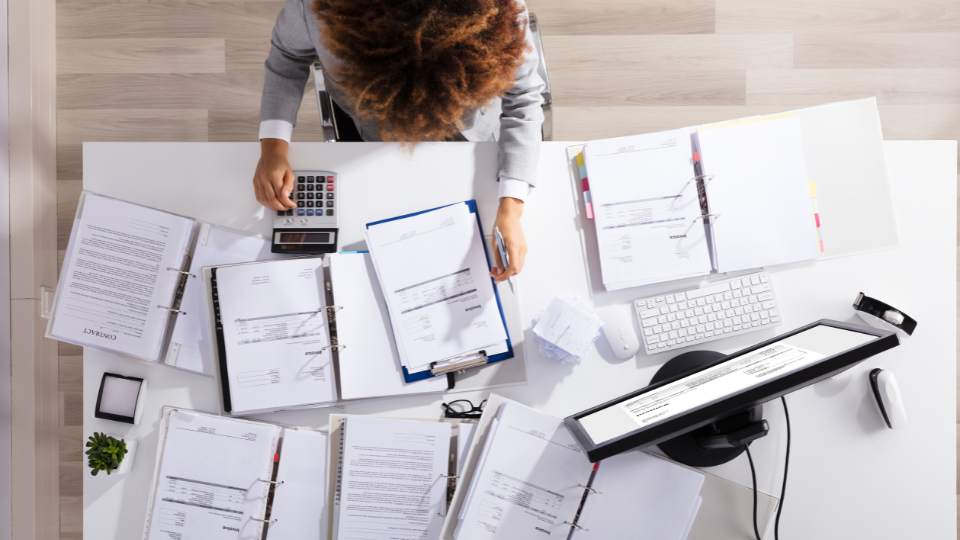 An overhead view of a person working at their desk