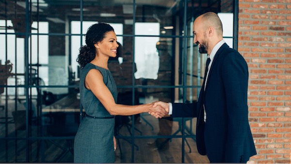 Two people shaking hands in an office