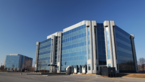 A large office building against a blue sky.
