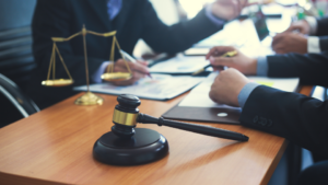 A group of business people sitting at a table discussing legal documents.